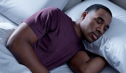 a man sleeping on a breeze mattress
